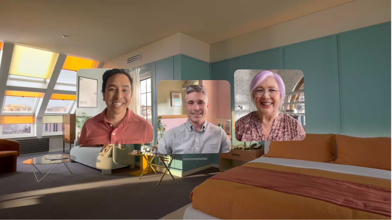 A FaceTime call on Apple Vision Pro, showing three tiles from other participants overlaying the user’s room.
