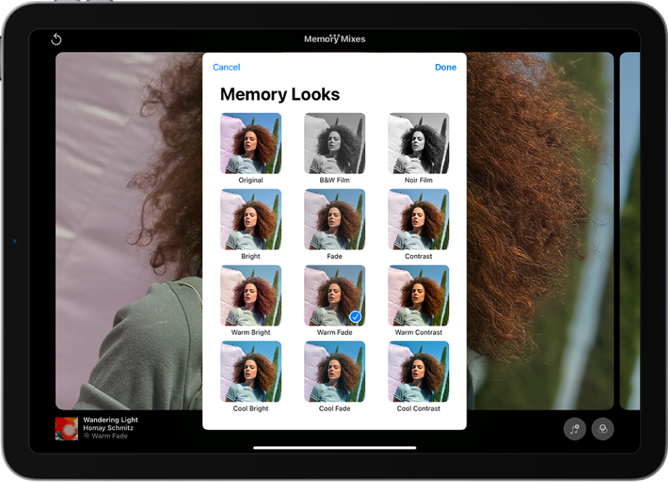 A memory is playing in the middle of the screen. At the bottom of the screen, from left to right, are the Memory Mixes, Photos, and Movie buttons. At the top right are the Volume, More, and Close buttons. At the top left are the title of the memory and the name of the song and artist playing.