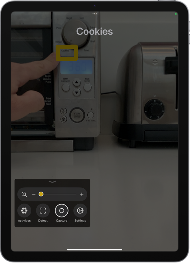 The Magnifier app detecting a finger pointing at text on a kitchen appliance.